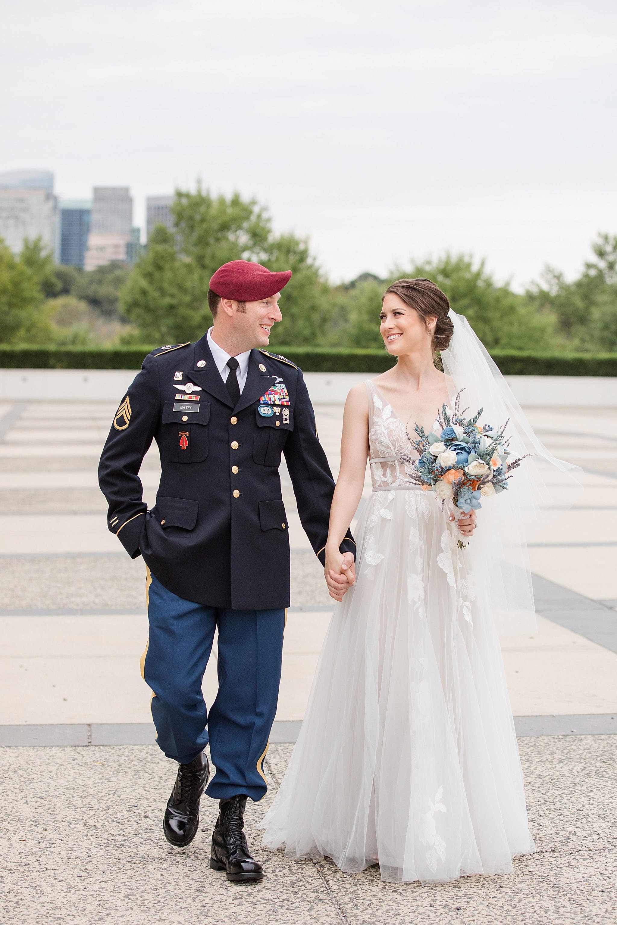 A wedding couple hold hands and walk together.