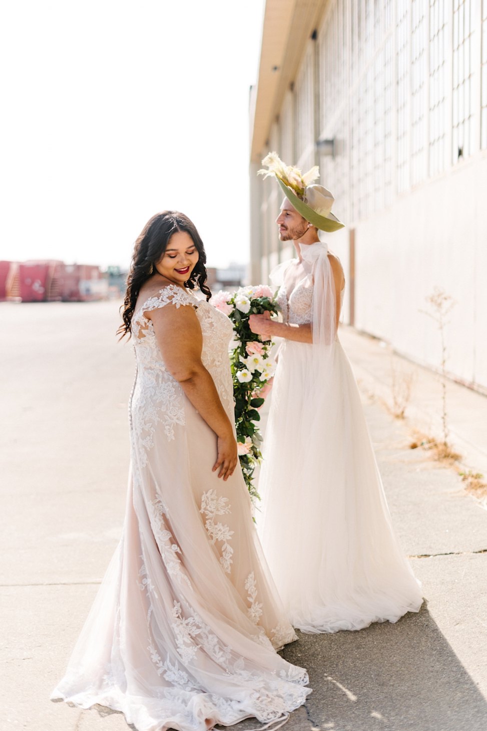A woman and a man wear Maggie Sottero wedding dresses.