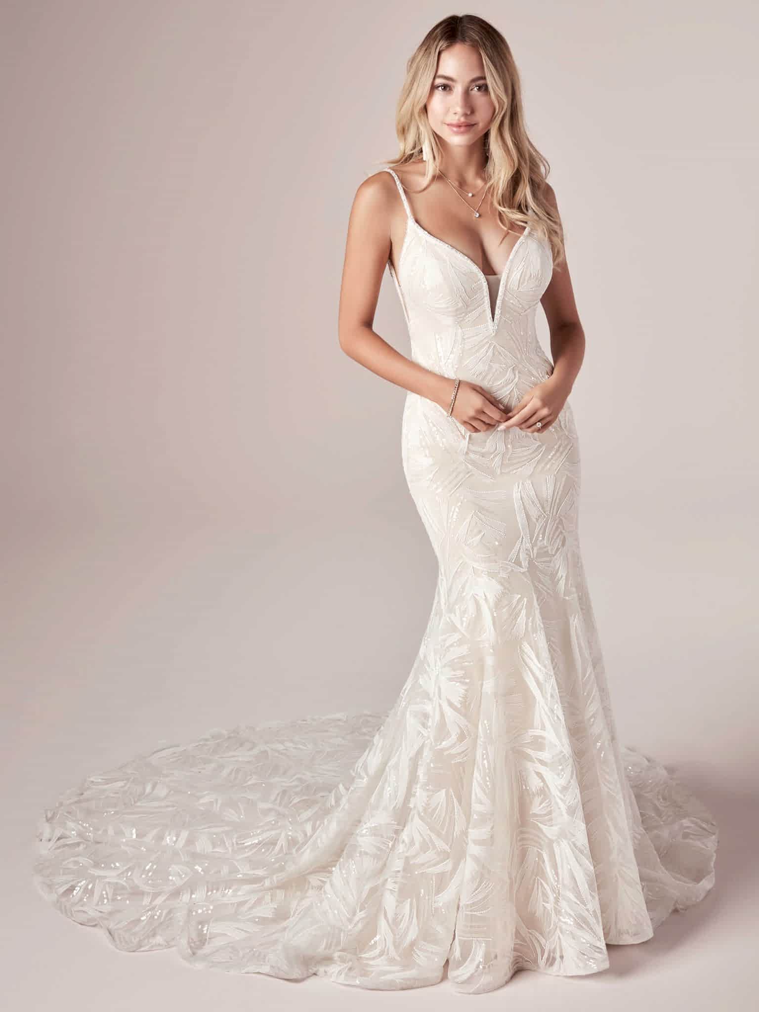 A woman wears the Elsie by Maggie Sottero