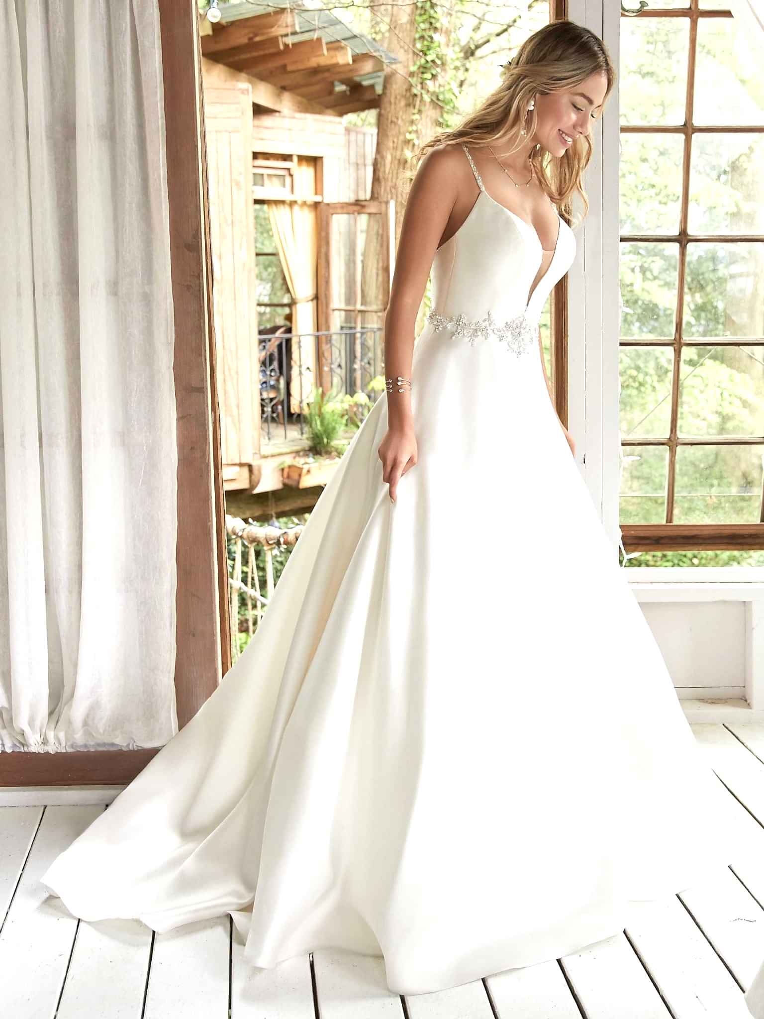 A woman wears Yara by Maggie Sottero
