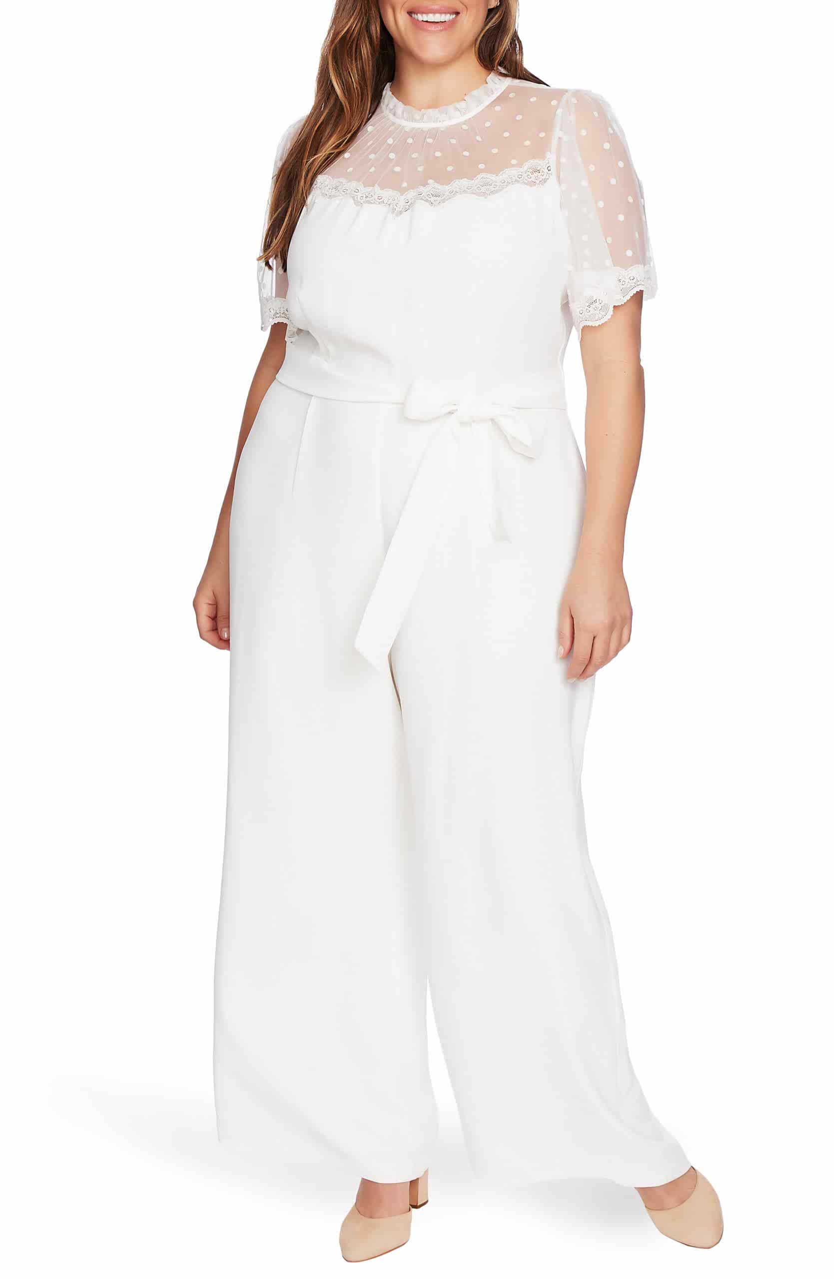 Achieve a lovely look in record time with a one-and-done jumpsuit yoked in illusion lace spotted with flocked dots.