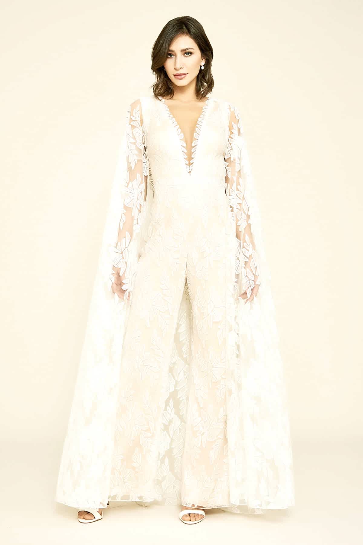 A tulle inset ensures the plunging neckline stays in perfect place, and a petal pink lining gives this ivory jumpsuit a subtle tint.