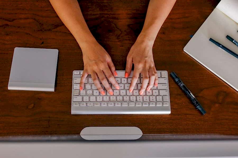 woman typing on a keyboard