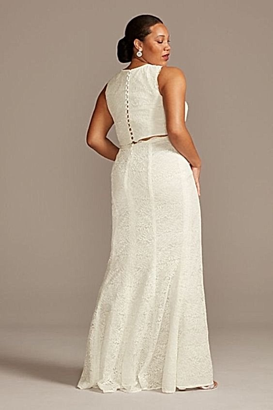 A model wears wedding separates and poses with her back to us.
