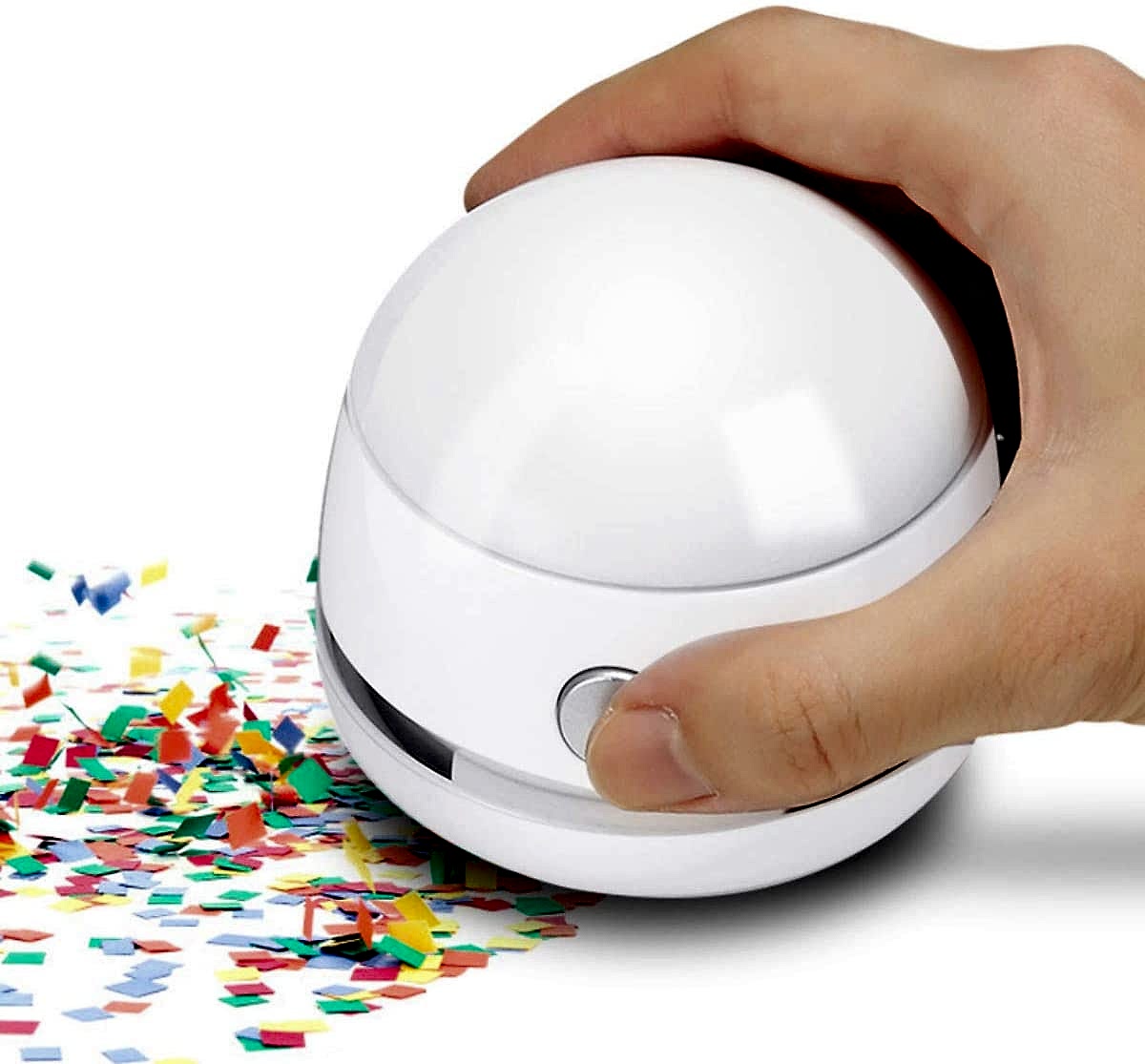 hand vacuum sucking up confetti