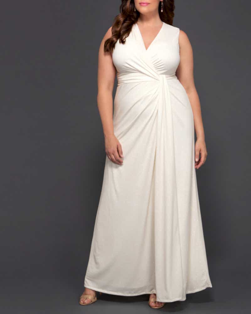 Woman with dark hair in simple white wrap style dress