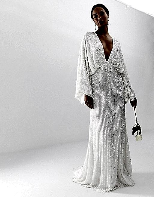 Woman with dark hair in off the rack white plunging neckline wedding dress