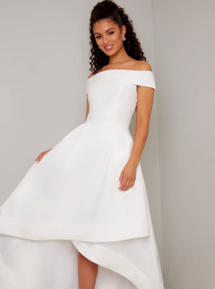 Woman with dark hair in off the rack white full skirt wedding dress