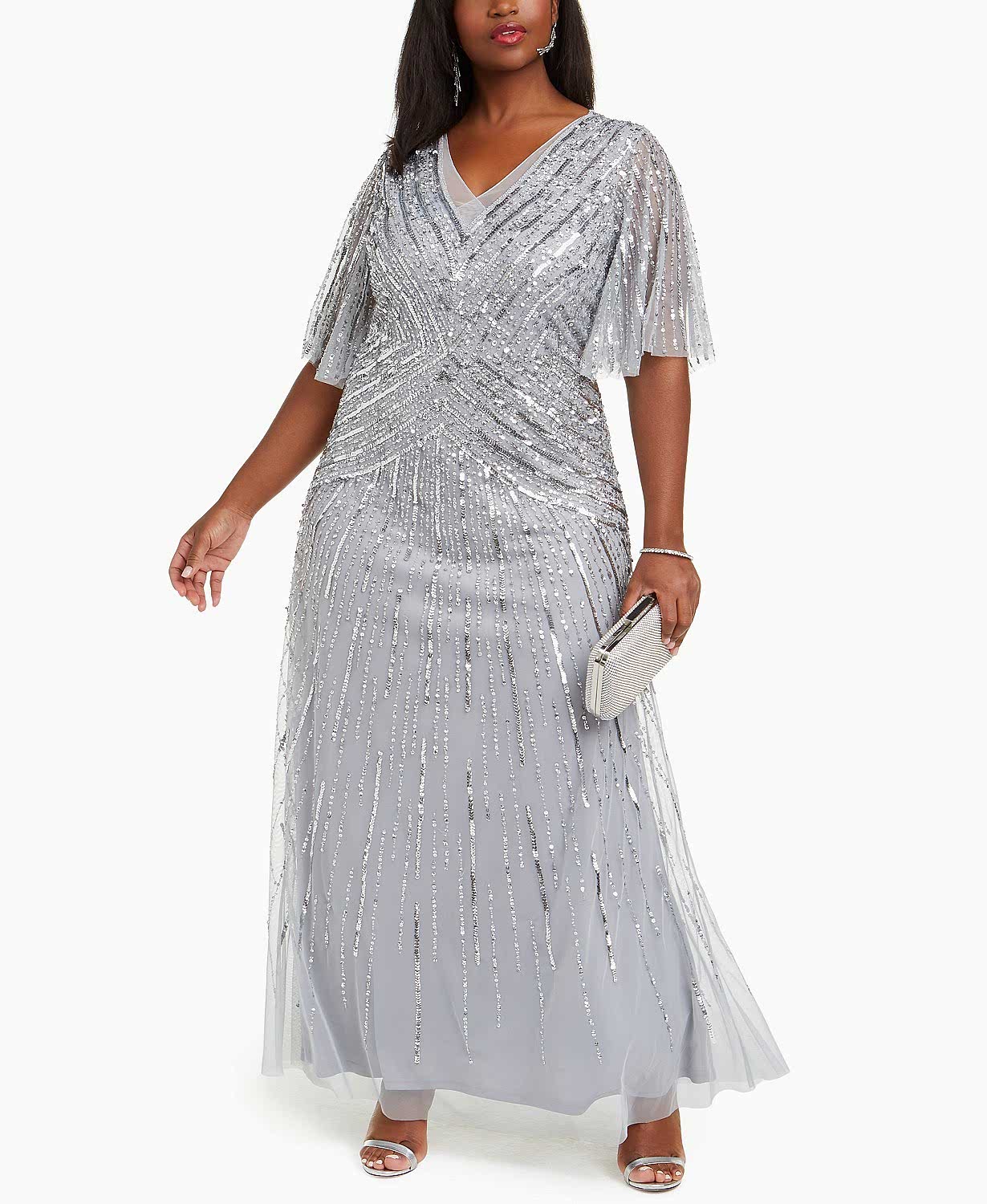 Woman with dark hair in a grey and sequined dress