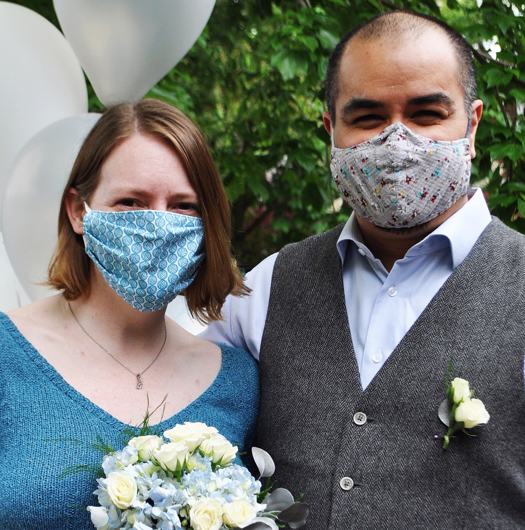 Couple in masks getting married in a backyard