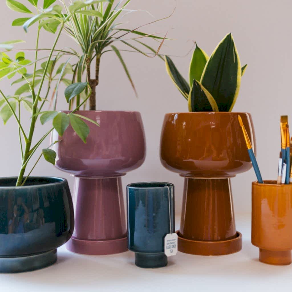 multicolor 3 piece planters on a desk
