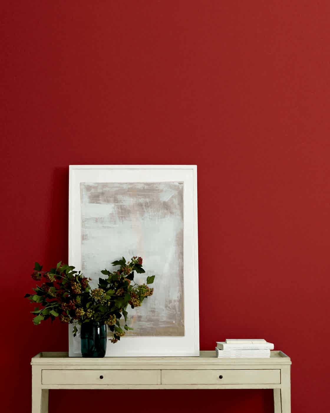 red paint from black womxn owned business, Clare, on a wall with a console table in front of it