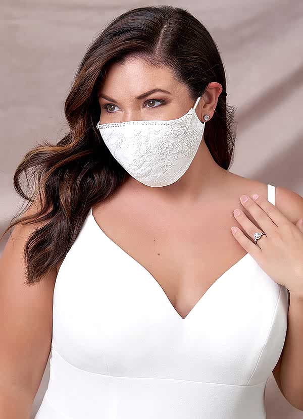 woman wearing a white lace mask and simple white wedding dress