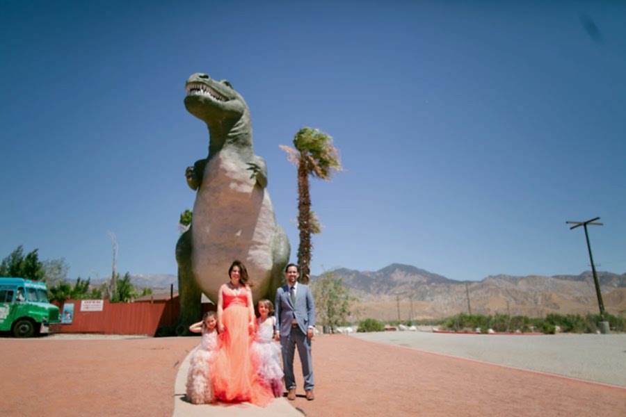 Meg, David and the kids in front of a giant dinosaur