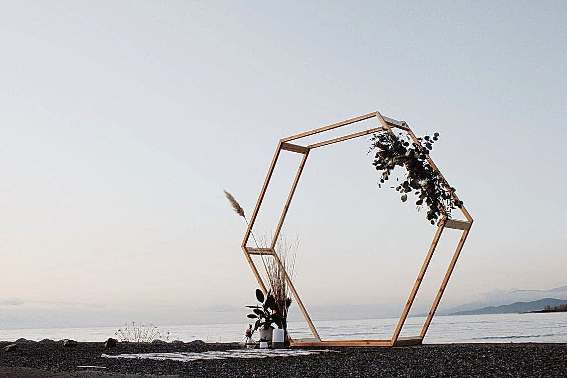 hexagon wedding arch with minimal florals at the waterfront