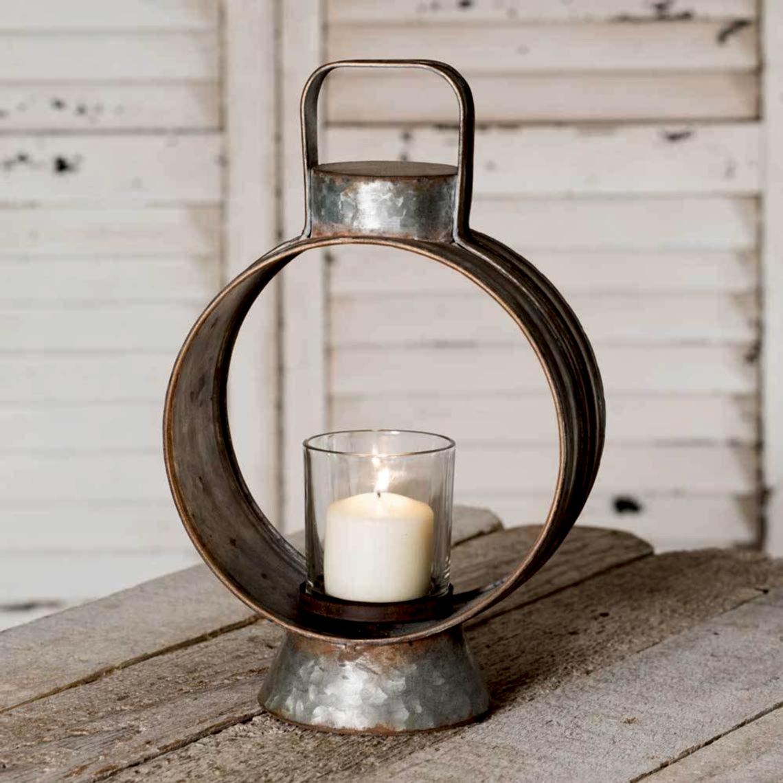 Round metal table top lantern with glass candle holder in the middle