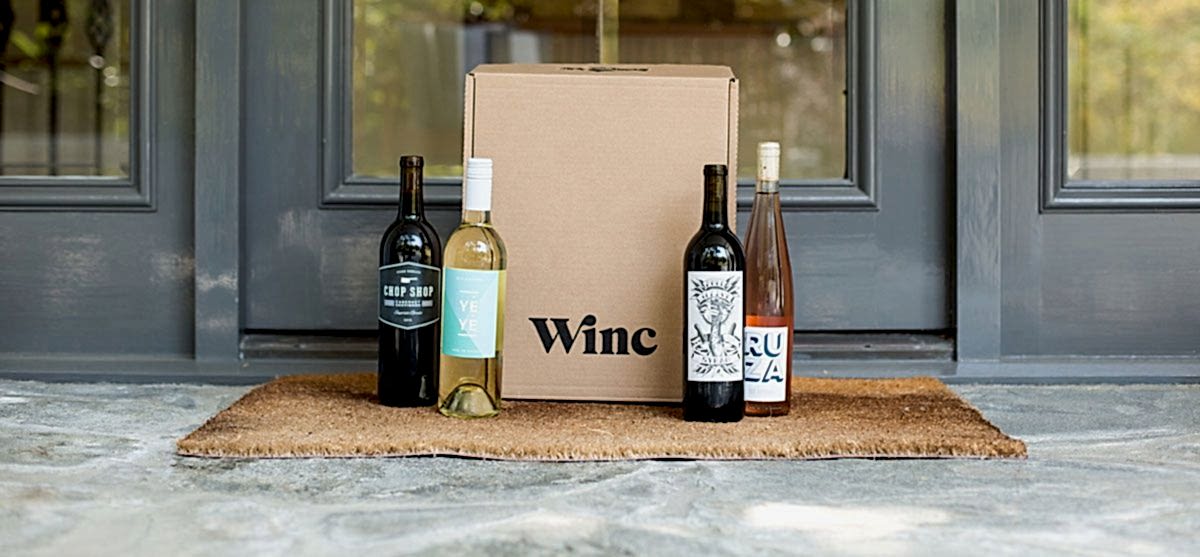 Box and bottles of Winc wine on front porch