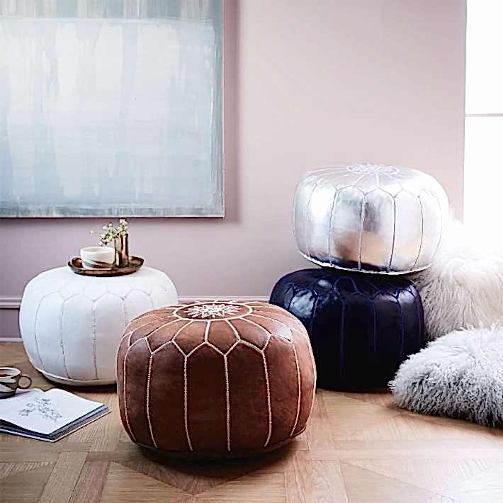 Brown, White, and Silver Leather ottomans in front of pink walls