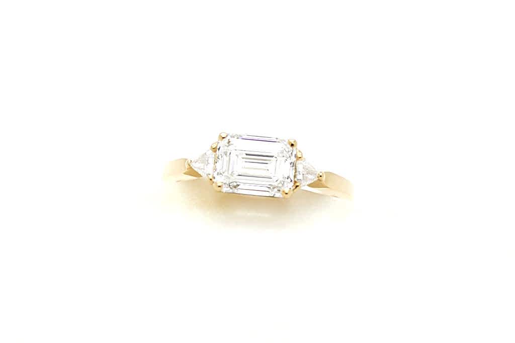 Close up photo of gold and square diamond engagement ring