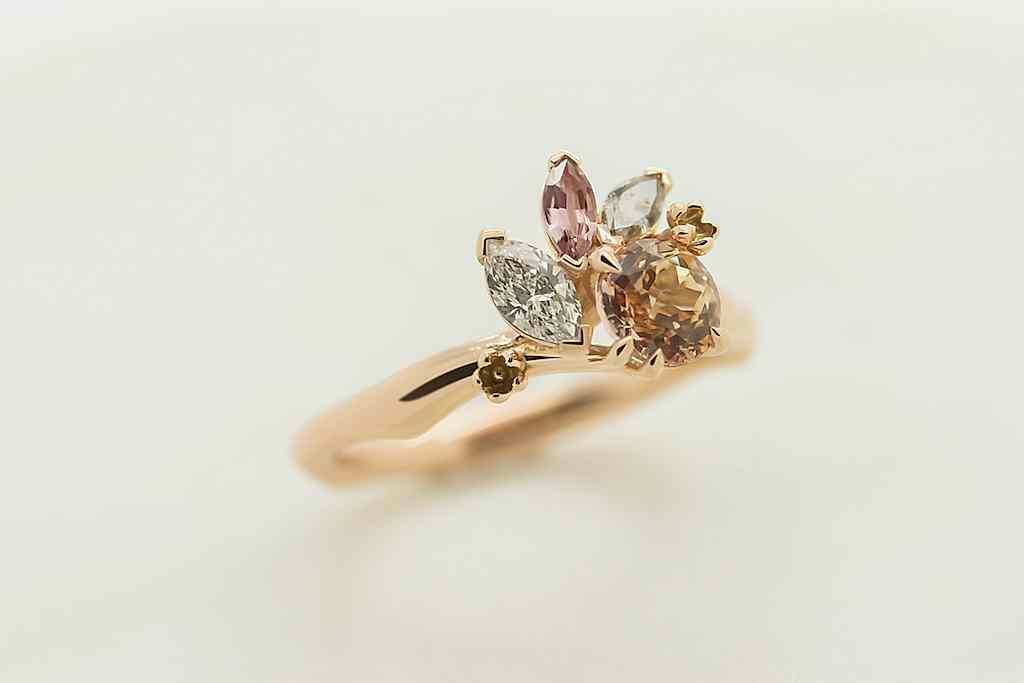 2020 proposal ideas: close up of gold and multi color stone engagement ring