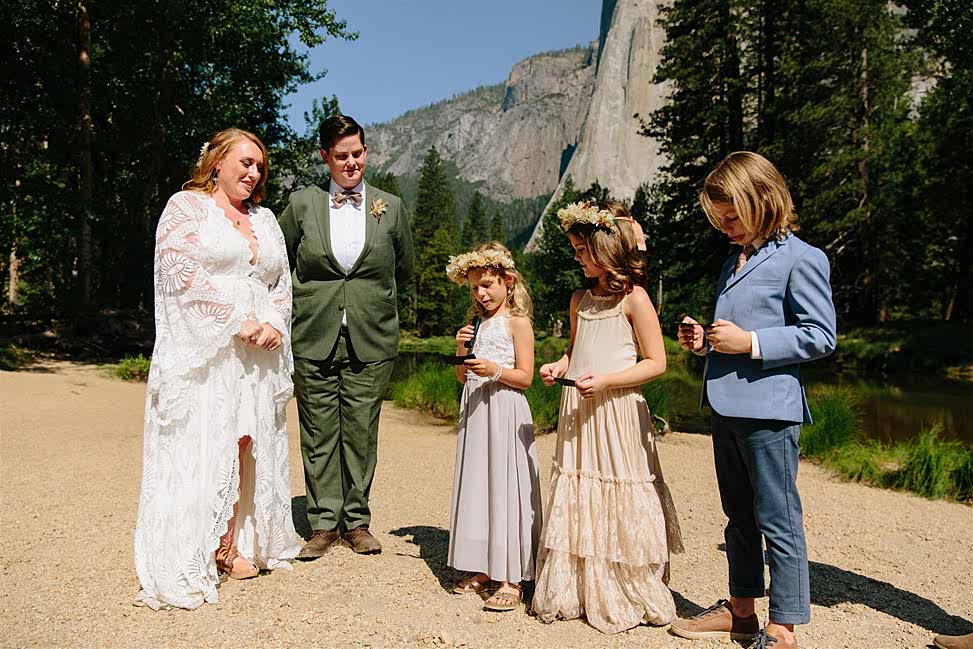 Couple watching three small children read a wedding poem during their ceremony