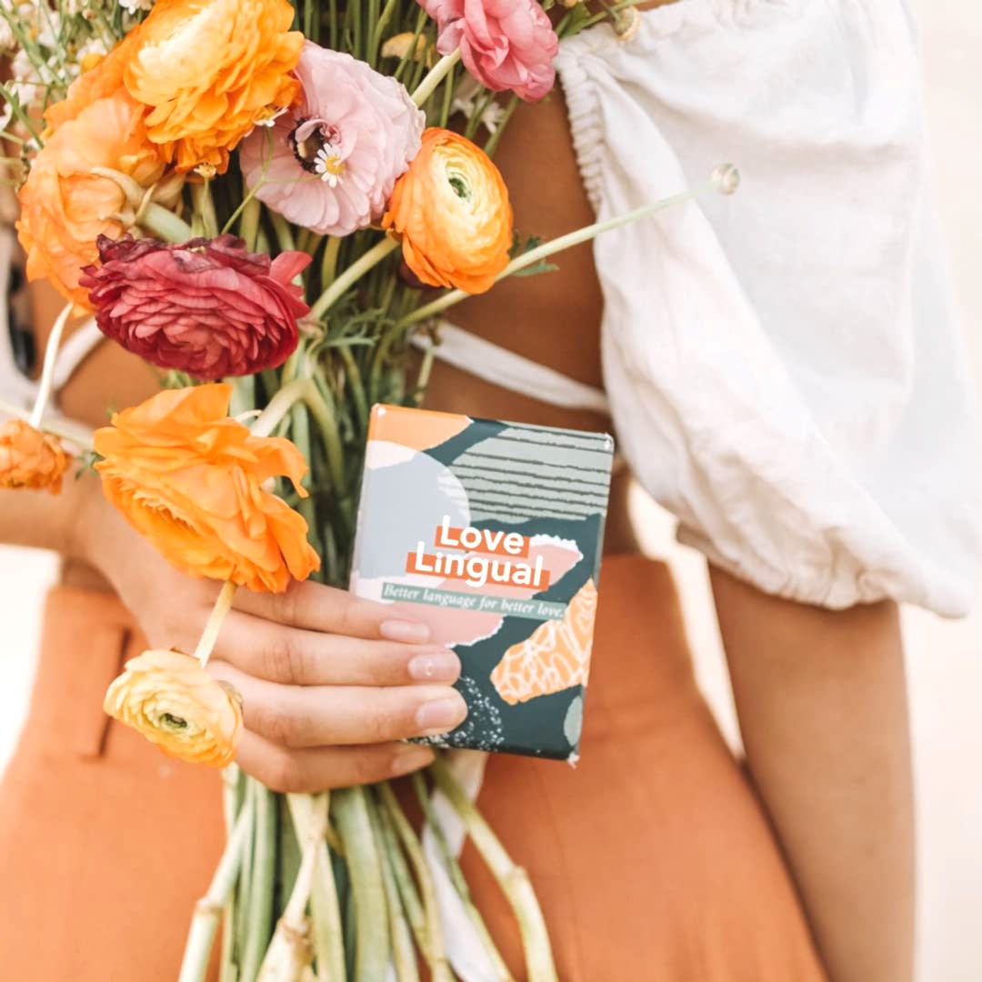 Woman holding flowers and deck of cards called "love lingual"